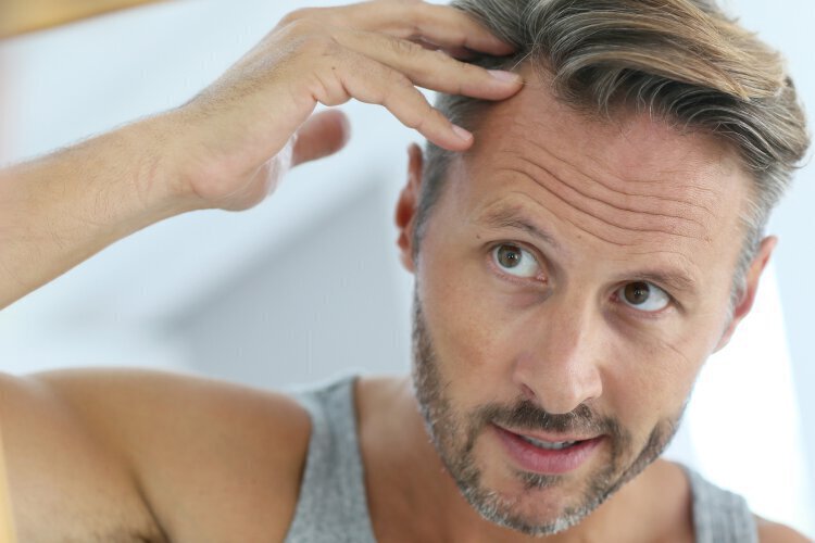 Long Island Hair Loss treatment model looking in mirror